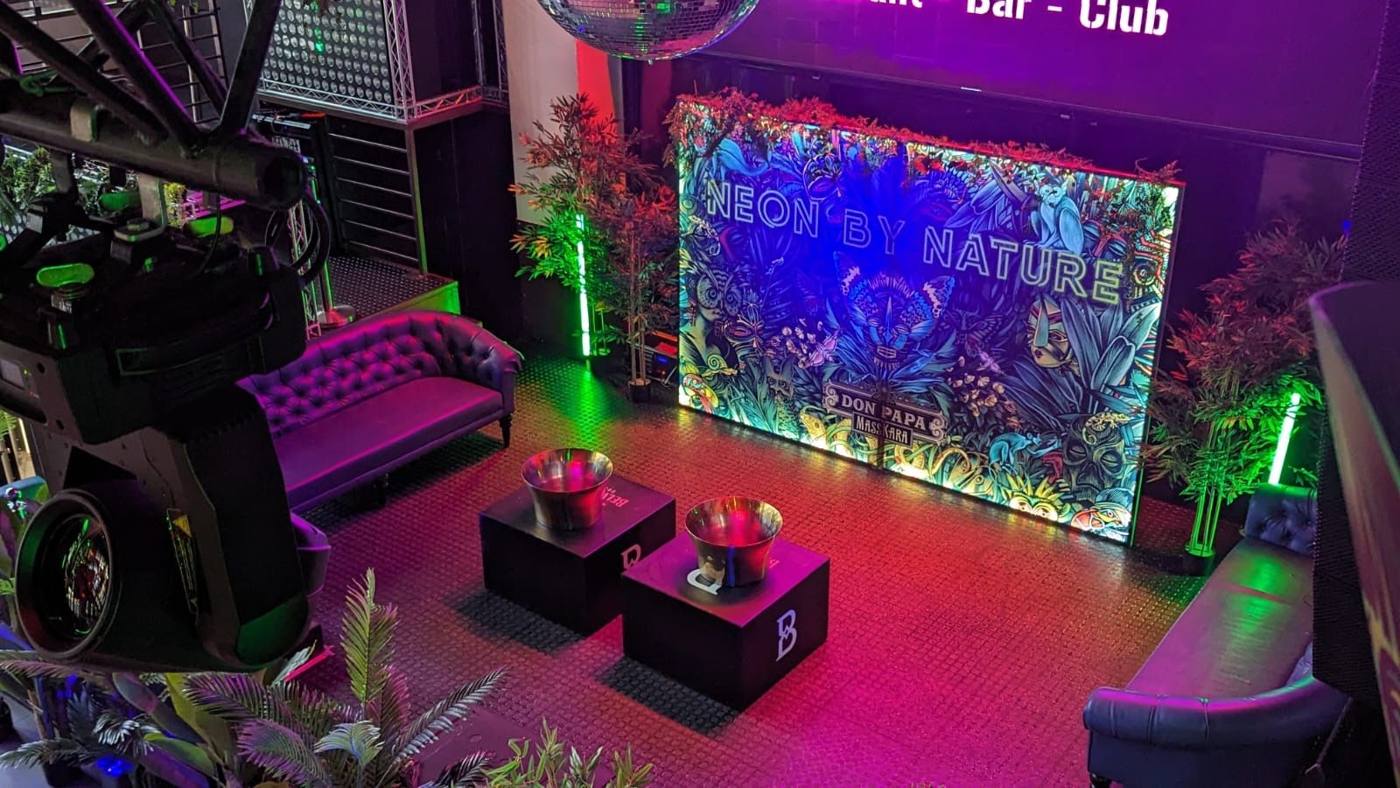 Décor « Neon by Nature » Don Papa, lumières vertes et roses.